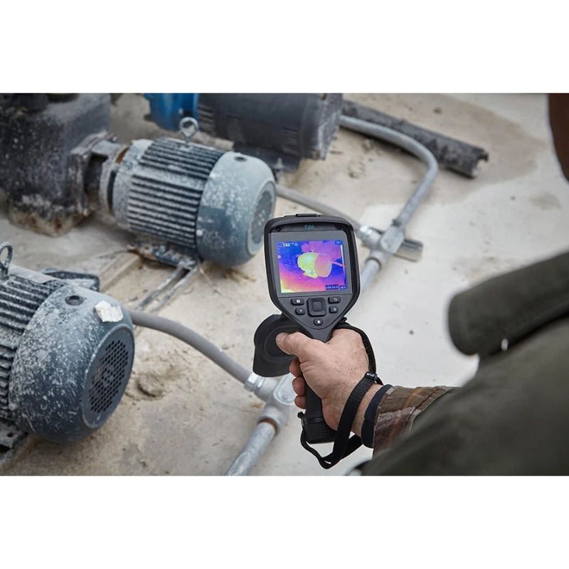 FLIRE86 Person using a thermal imaging camera on industrial equipment